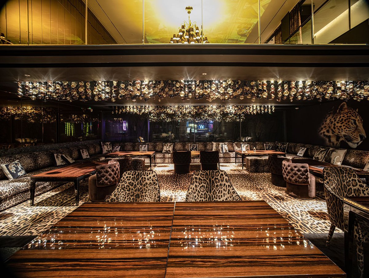 Custom crystal orb chandelier installation in luxury restaurant